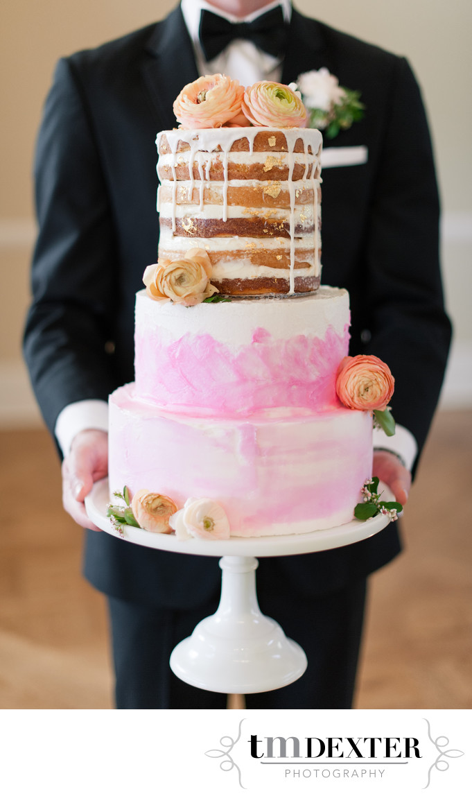 Groom Holding Wedding Cake at Flying Horse