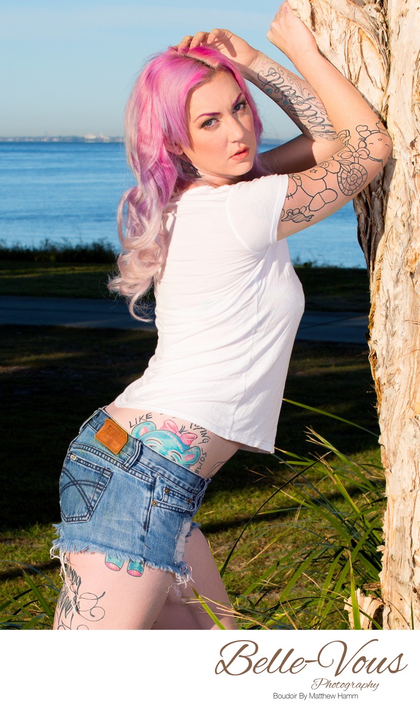Model With Pink Hair Posing Next To Tree