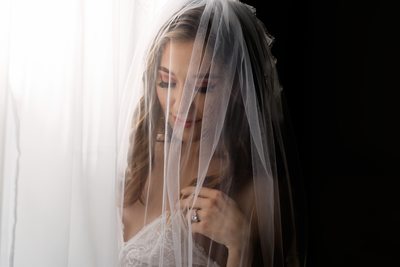 Bridal boudoir Brisbane with lace veil and soft lighting.