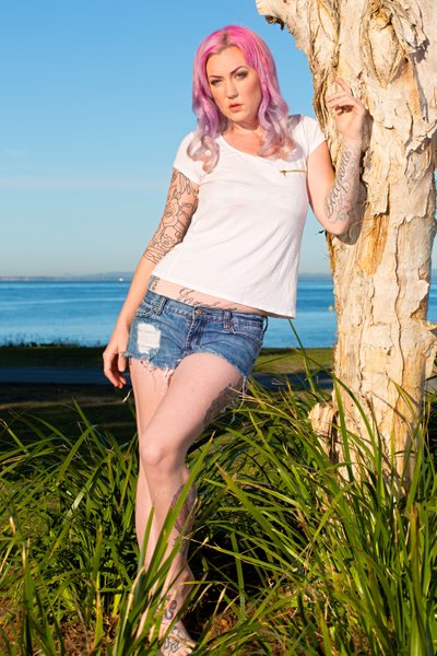 Model With Pink Hair Posing In Long Grass