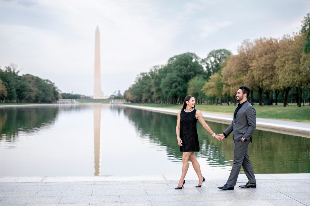 Engaged Couple Walking by Reflecting Pool