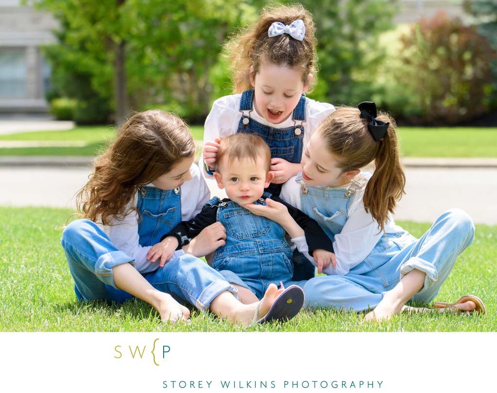 Baby Brother Surrounded: Sisters' Love on the Lawn