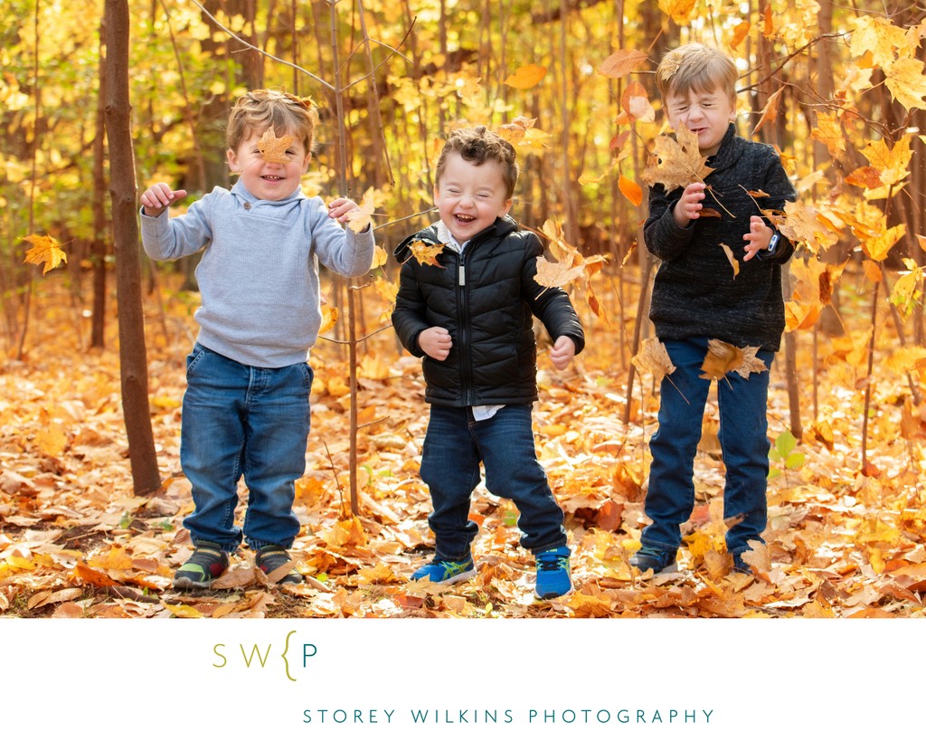 Cousins Playing in Fall Leaves Portrait