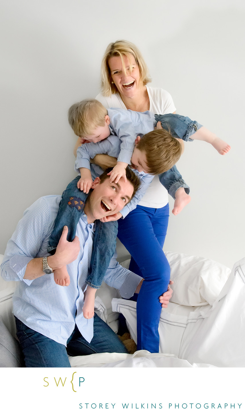 Fun Family Pile-Up on the Bed Portrait
