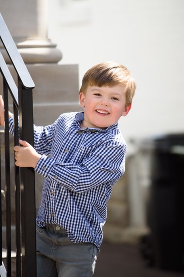 boy on stairs during family portrait