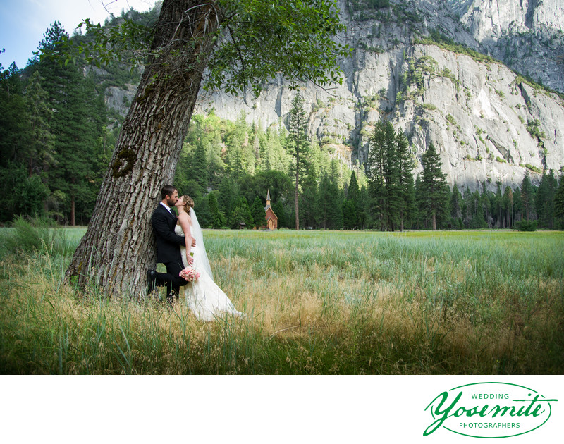 Yosemite Wedding Chapel Just Married Couple Kissing near a tree