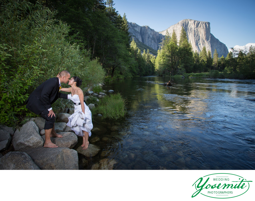 A Couple dips their toes in the Merced River, Yosemite Valley