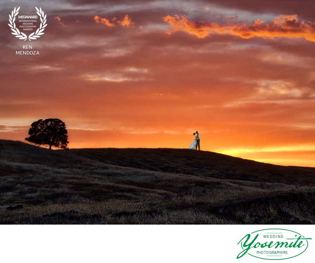 Sierra foothills wedding photo - couple kissing at Sunset