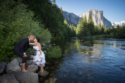 A Couple dips their toes in the Merced River, Yosemite Valley