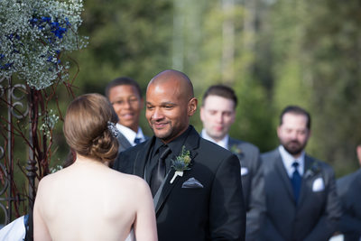 Groom Beams At Bride During Tenaya Lodge Wedding Ceremony.