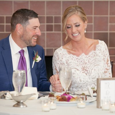 Couple sharing a smile over their first dinner as husband and wife
