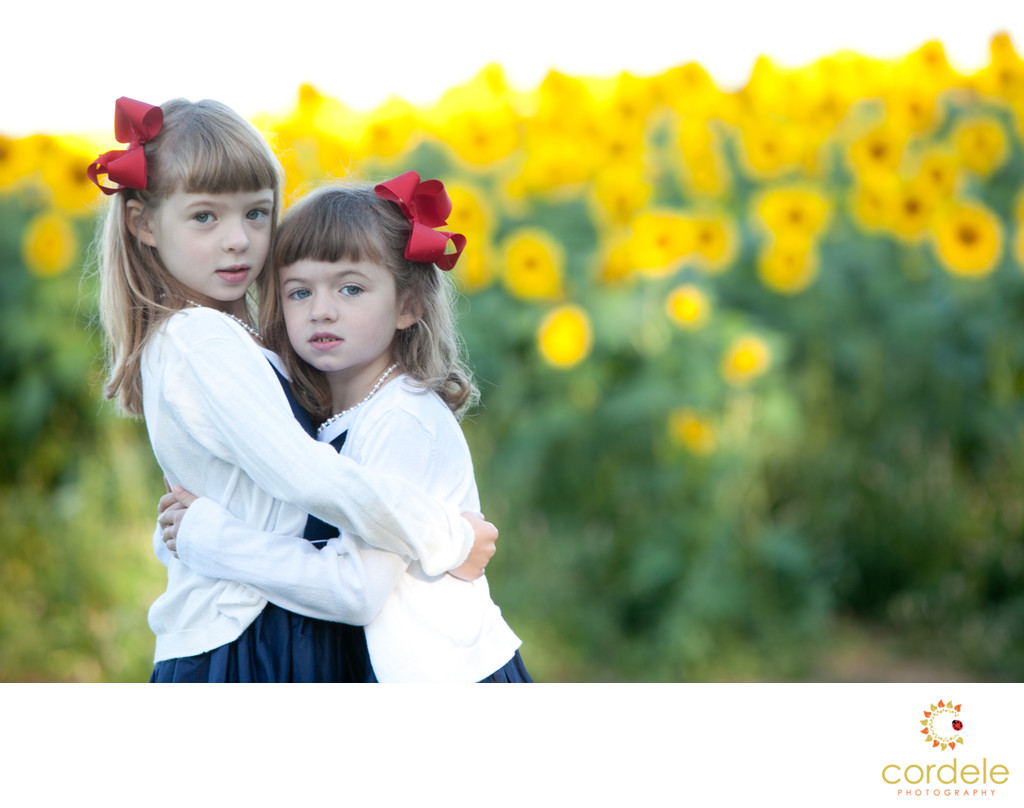 portrait of sisters in sunflower field at Colby Farm