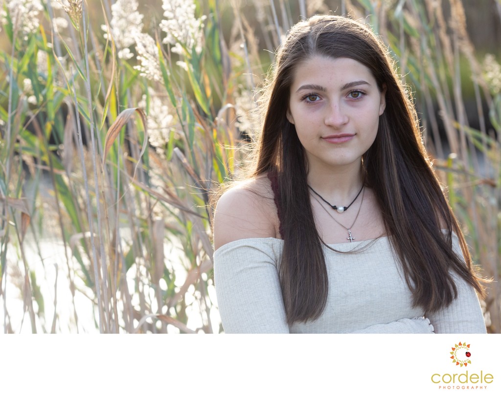 A senior portrait before and after taking in Gloucester Massachusetts with tall grass. Click here to see more before and after 
