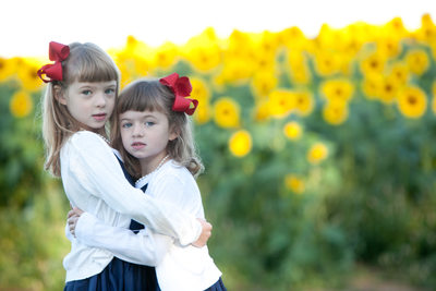 portrait of sisters in sunflower field at Colby Farm