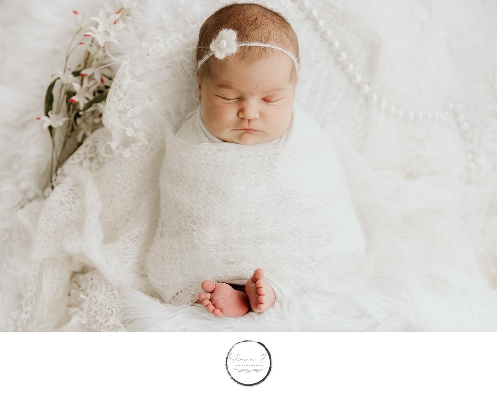 Boho Newborn Photography: baby in white