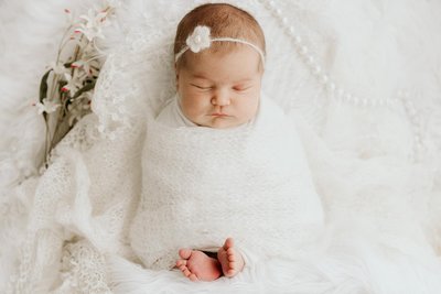 Boho Newborn Photography: baby in white