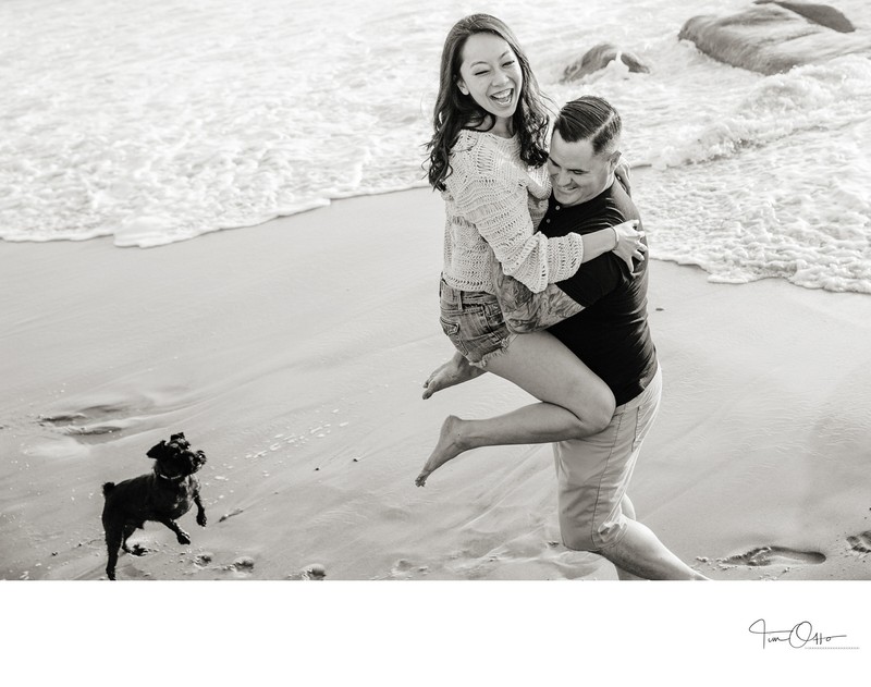 fun engagement photo with dog and the beach