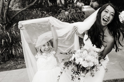 Candid photo of bride and flower girl Estancia Wedding.