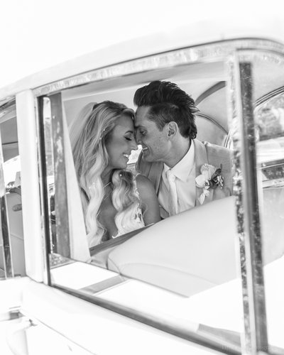 bride and groom in car