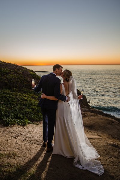 Bride and Groom Champagne Cheers at Sunset in La Jolla
