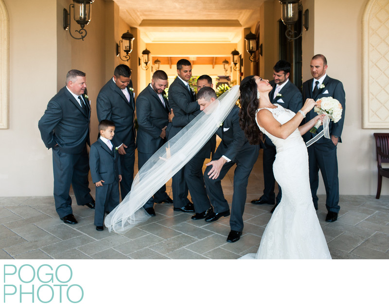 Groomsman Steps on Bride's Veil During Formal Photos