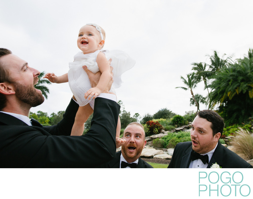 Groomsmen being silly with flower girl during formals