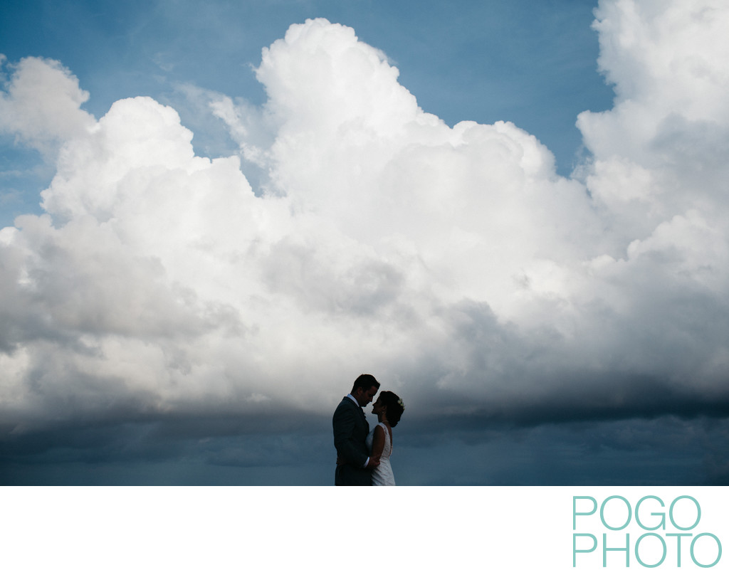 Silhouetted wedding portrait against dramatic clouds