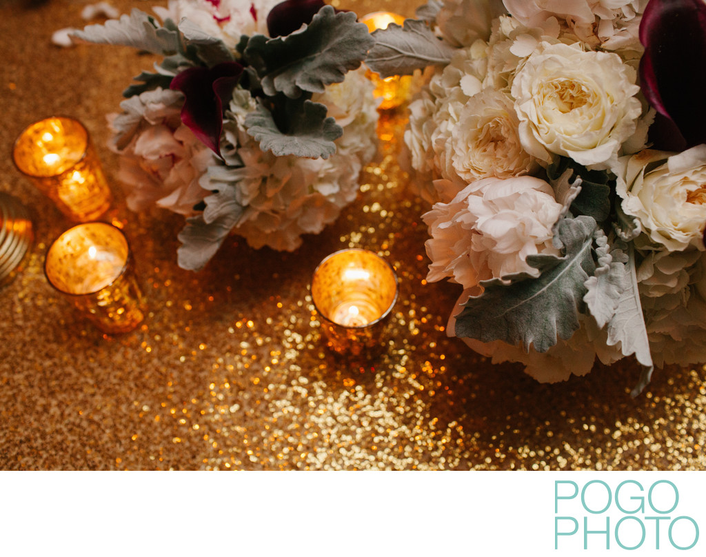 Gold sequined tablecloths at elegant black tie event