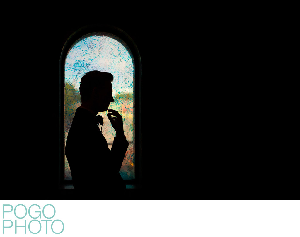 Groom Silhouette Portrait Against Colorful Window