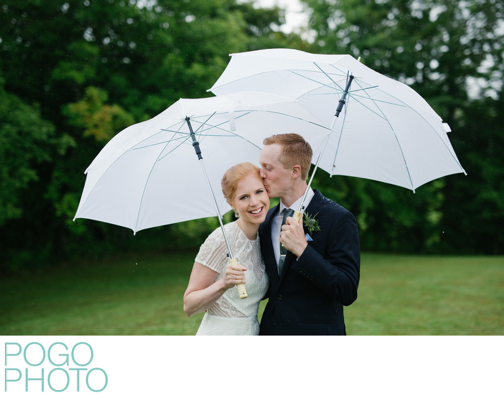 Rainy Day Wedding Photo of Redheaded Bride and Groom