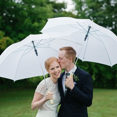 Rainy Day Wedding Photo of Redheaded Bride and Groom
