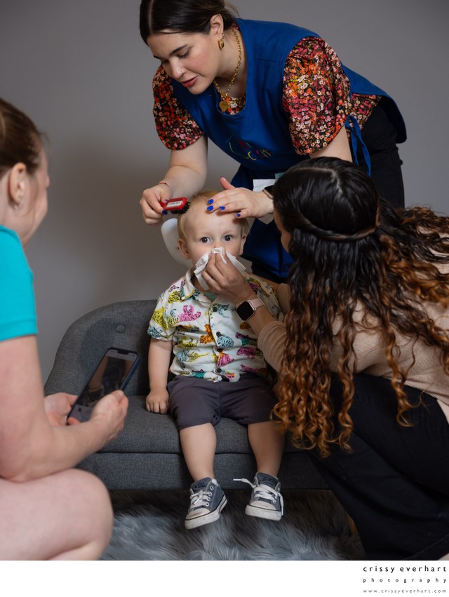 Teachers primp a student before his photo