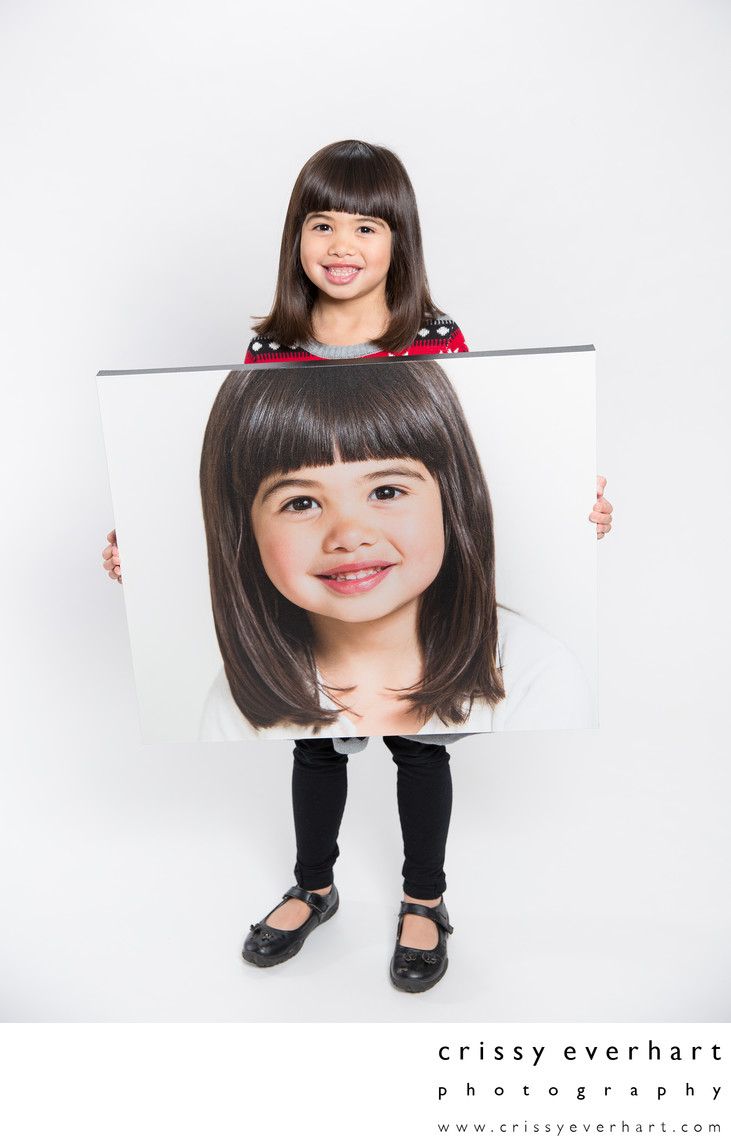 Six Year Old Holds Large Canvas Portrait of Herself