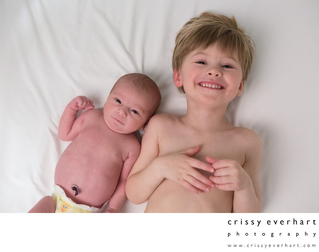 Newborn Portraits in Your Home - Brothers on Bed