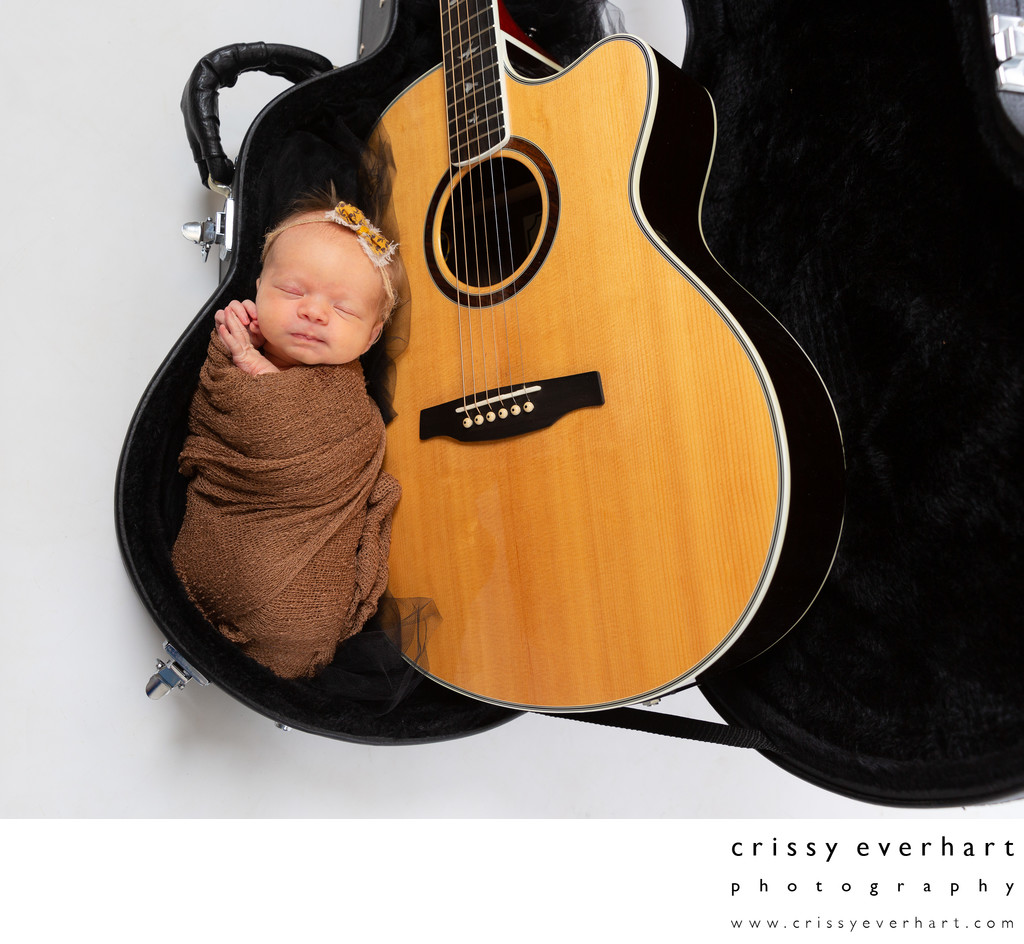Swaddled Newborn Baby Girl in Guitar Case