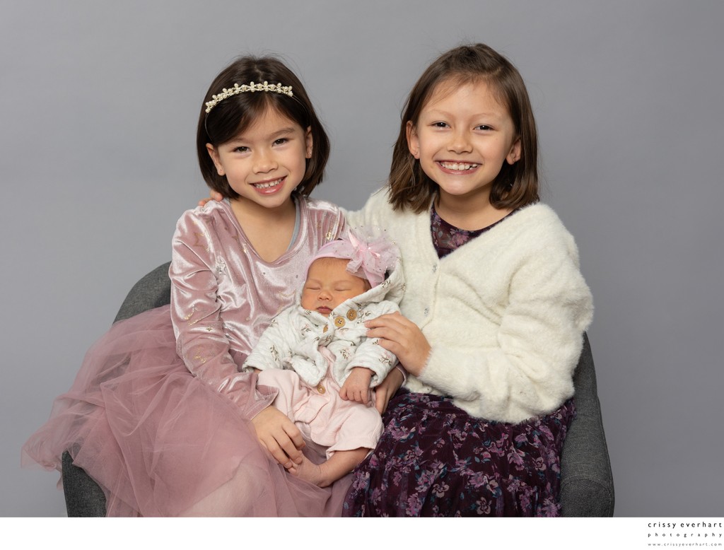 Studio Portrait of Newborn with Big Sisters