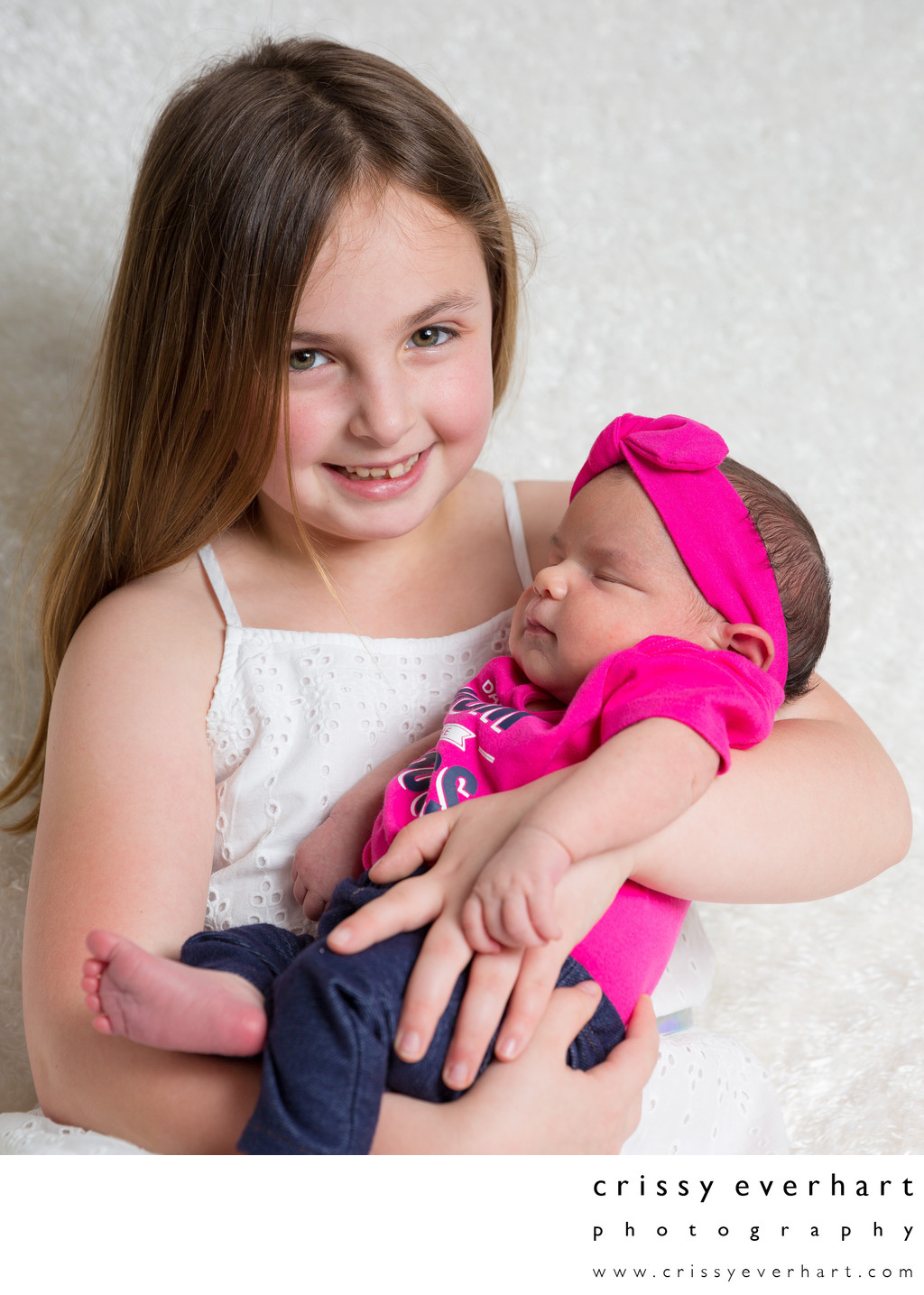 Proud Big Sister Holds Baby Sister