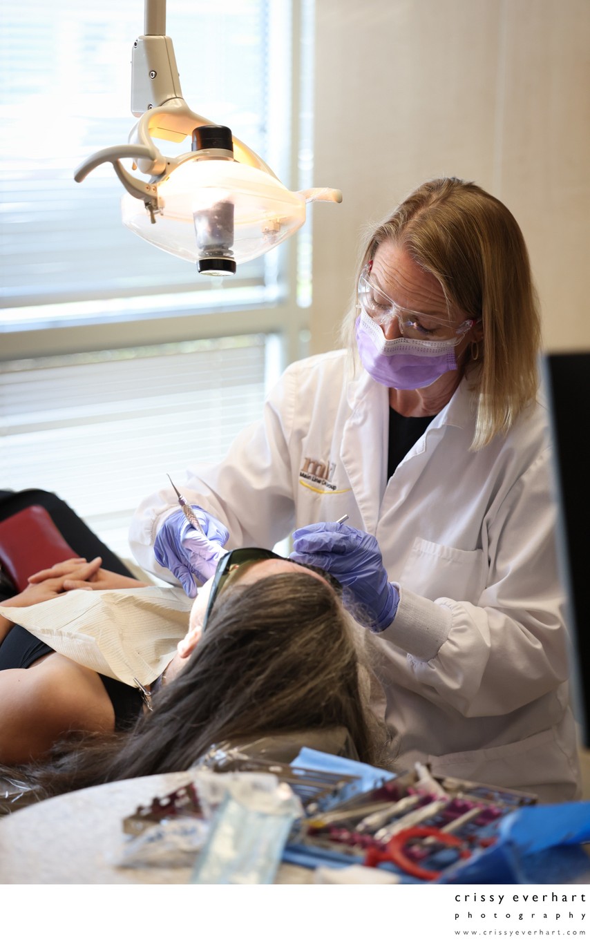 Dental Hygienist Working on Patient