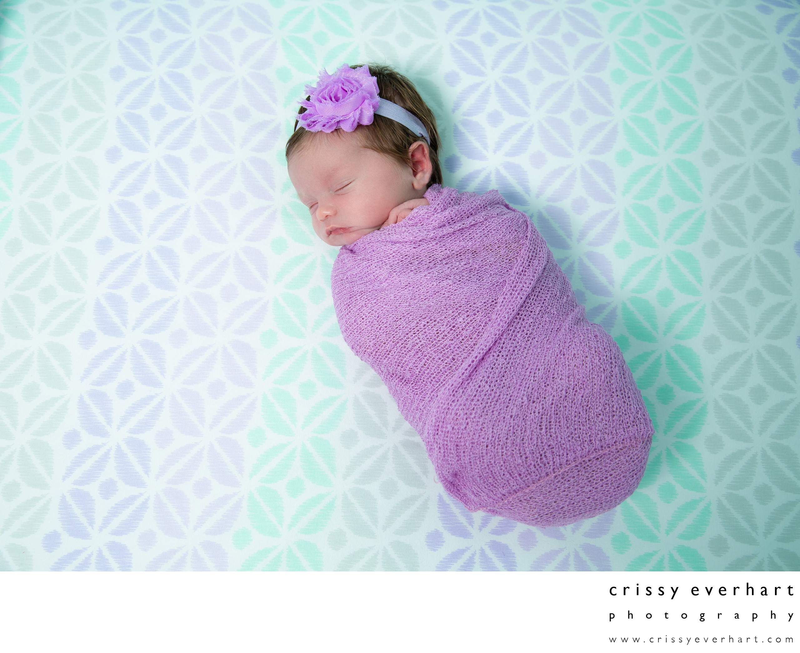 Swaddled Newborn in Crib, Purple and Teal