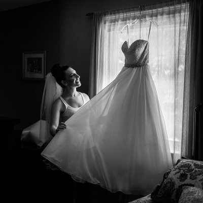 Bride with Wedding Dress by Window Light