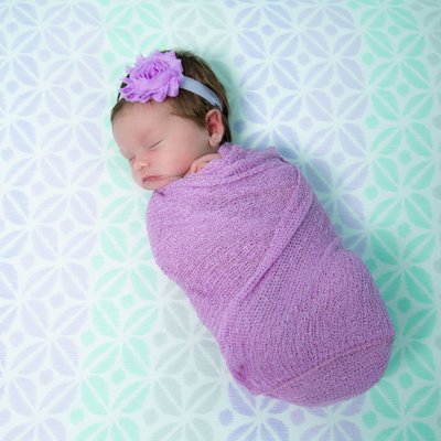 Swaddled Newborn in Crib, Purple and Teal