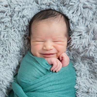 Smiling Swaddled Newborn Boy