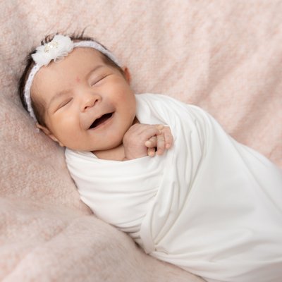Smiling Newborn Girl Photos