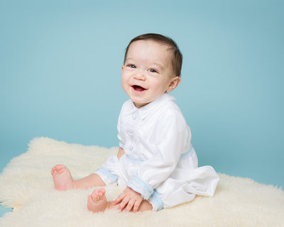 Smiling Baby - 8 Month Old on Blue Background