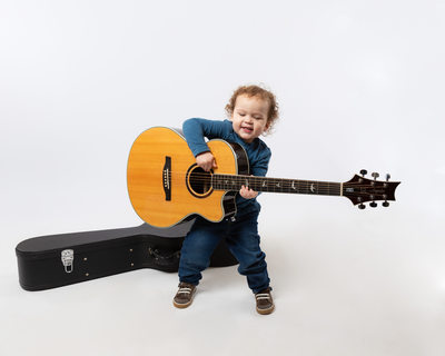 Studio Portraits of Active Toddlers - Boy with Guitar