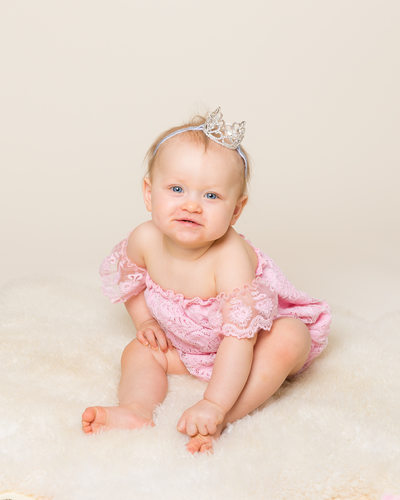 One Year Old Girl with Crown on Ivory Background