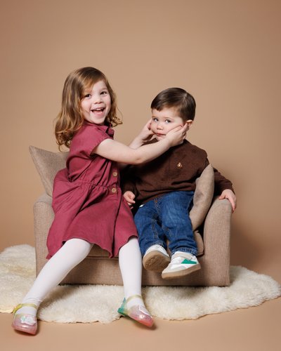 Big Sister Helps Brother Smile at Picture Day