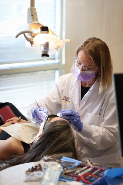 Dental Hygienist Working on Patient
