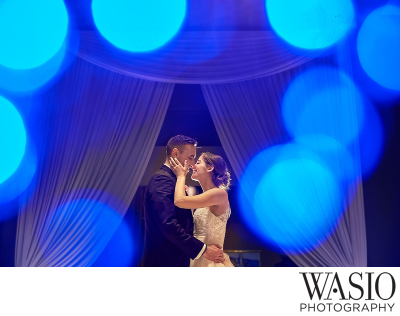 Evening portrait of couple kissing during reception