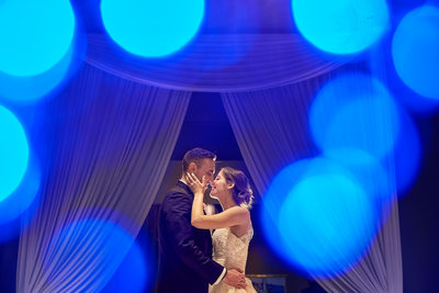 Evening portrait of couple kissing during reception